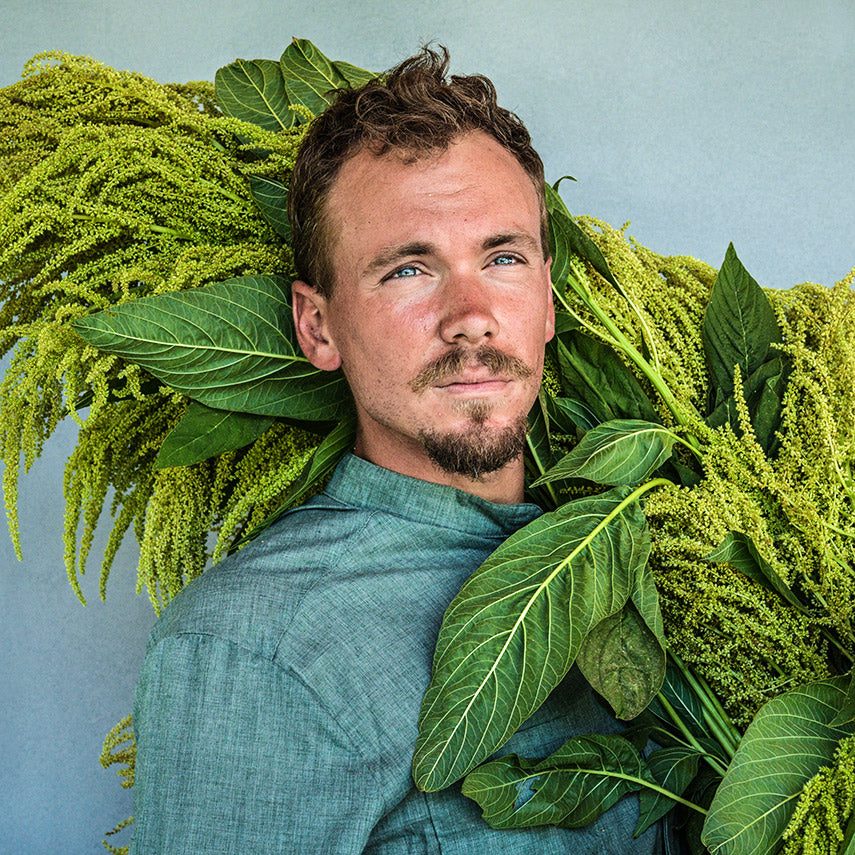 A portrait of the Baker Creek Garden manager with a bountiful harvest of Aurelia&