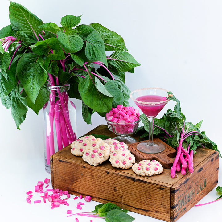 Chopped juiced and cookies made from Pink Beauty Amaranth on a white background.