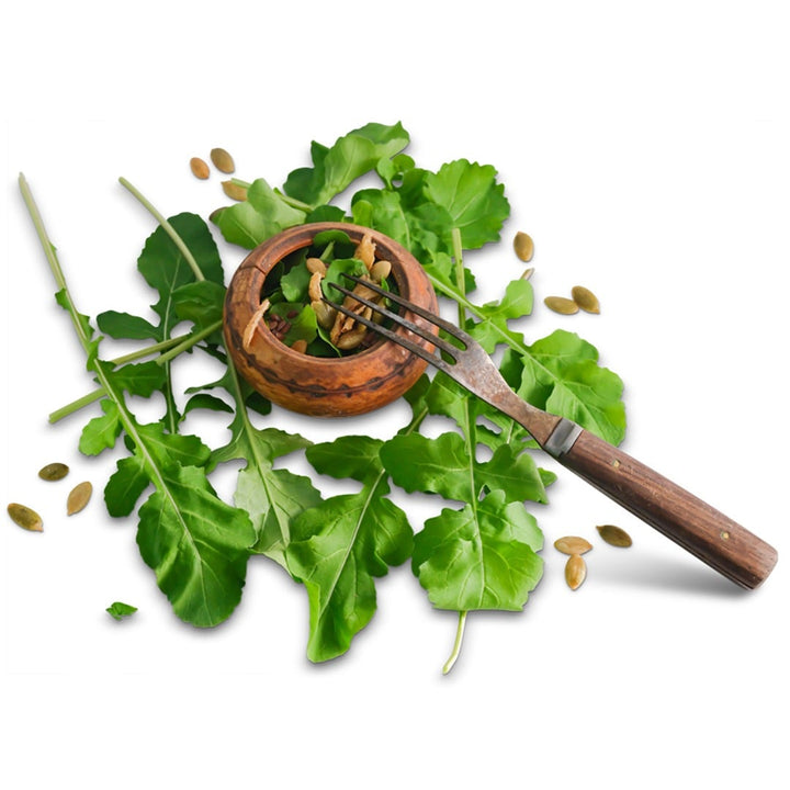 Common Arugula with a small salad and fork on a white background.