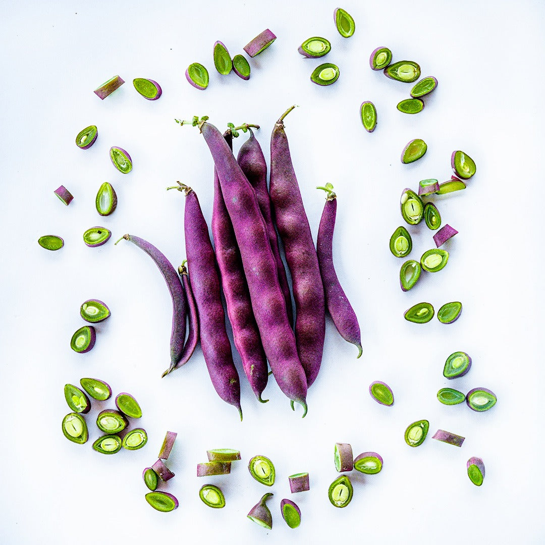 A pile of whole Red Swan Beans surrounded by chopped beans.