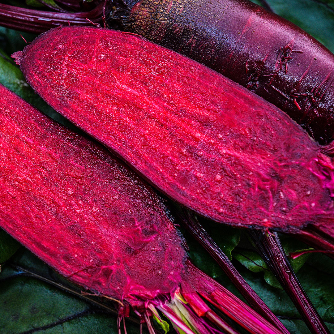 An extreme close-up view of sliced and whole Renova Beets.