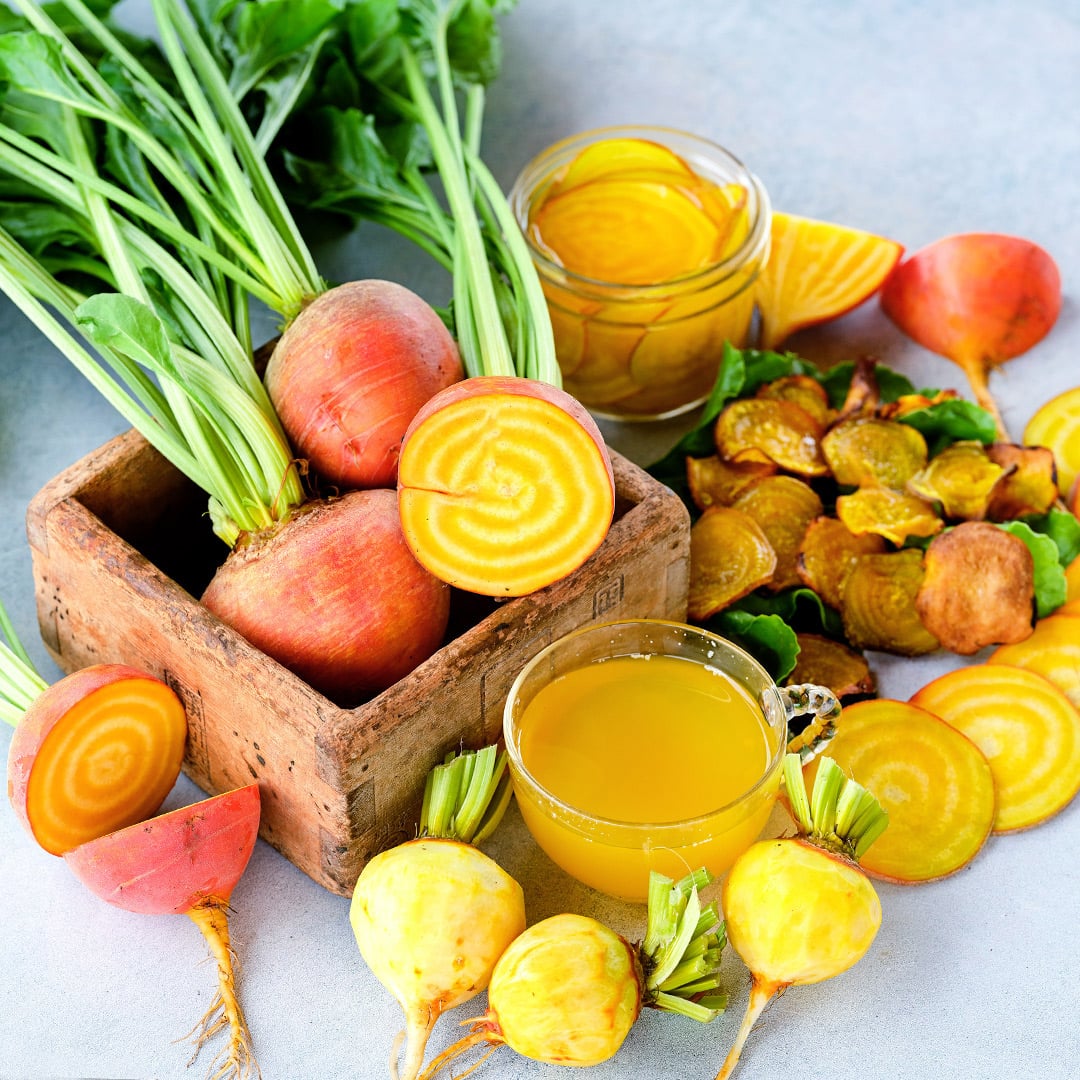 Cut and whole Golden Beets with beet chips and pickled and juiced beets.