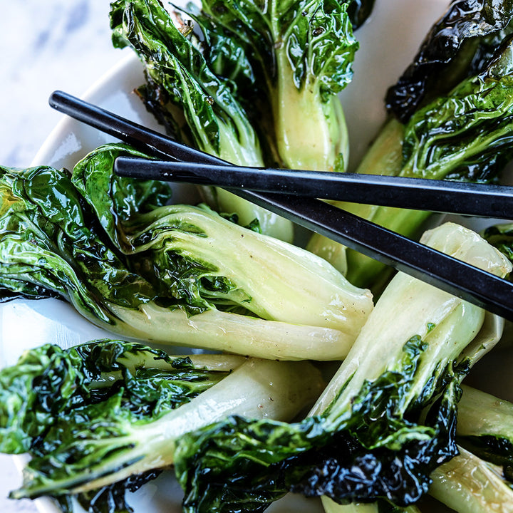 Sauteed Baby Milk Bok Choy in a bowl with chopsticks.