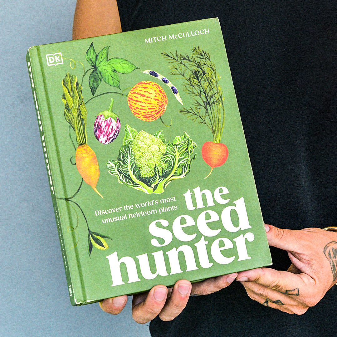 Mitch McCulloch holding his book The Seed Hunter.