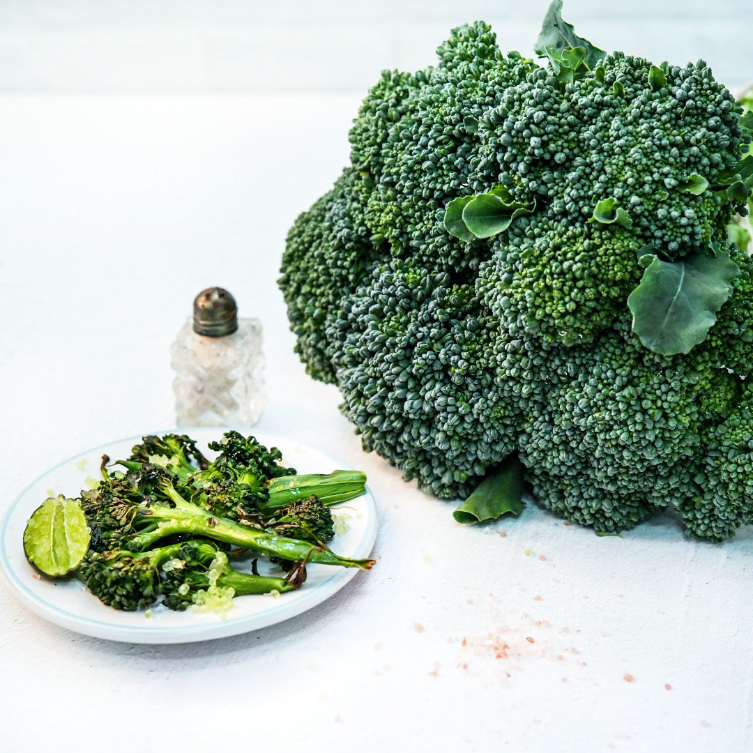 Waltham 29 Broccoli sauteed on a plate with finger lime seasoning and vintage salt shaker.