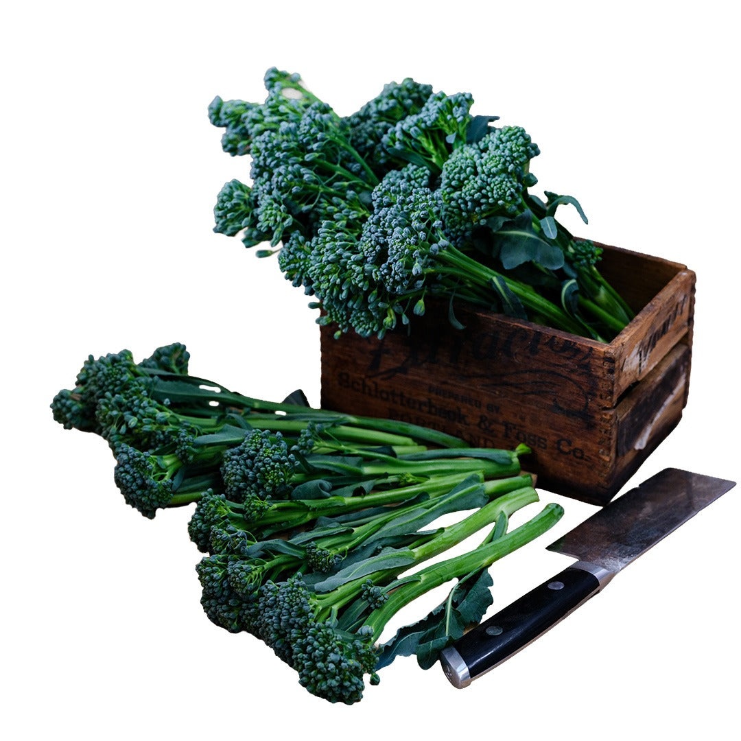Waltham 29 Broccoli in a wooden box and knife on a white background.