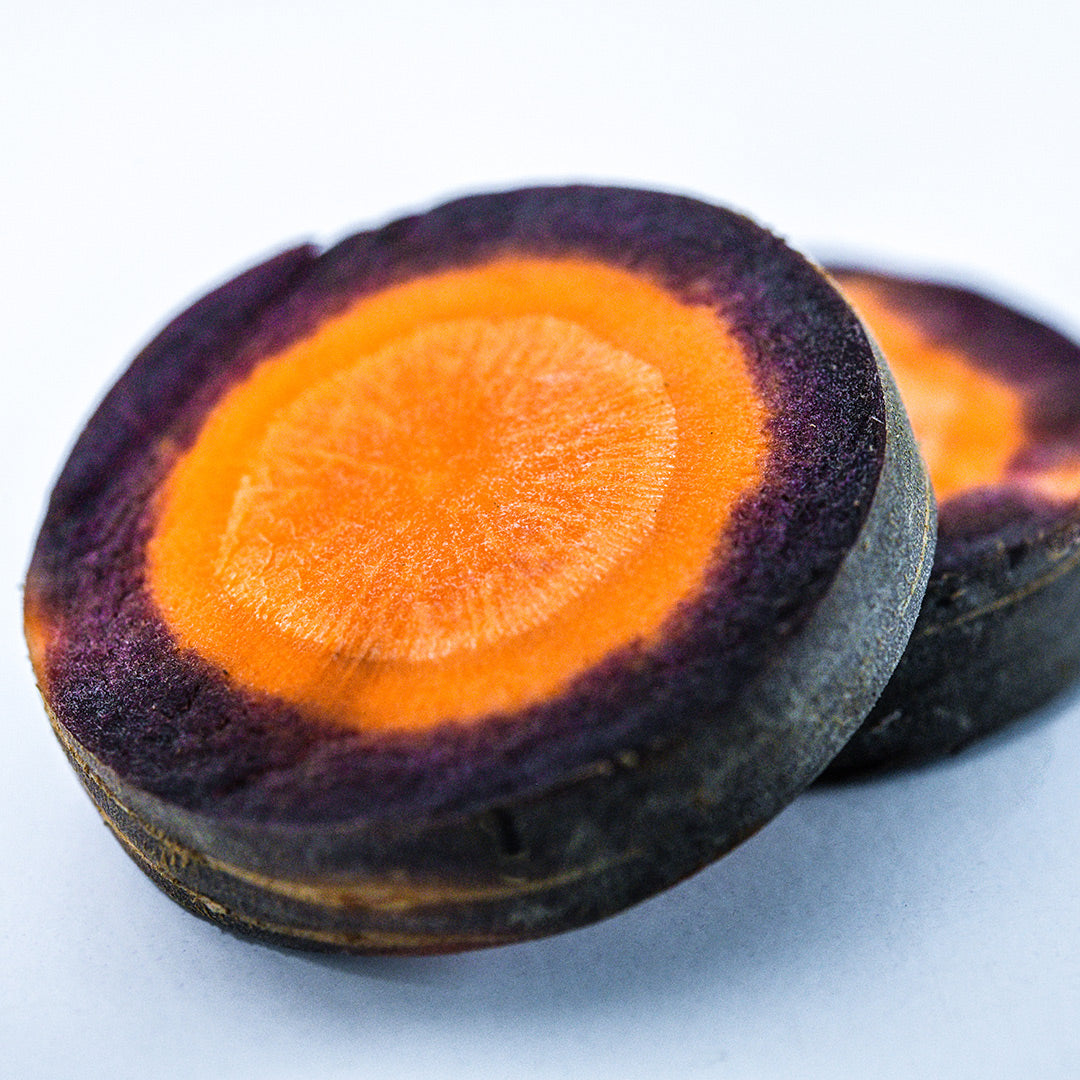 A close-up macro view of a couple of slices of Lila Lu Sang Carrots.