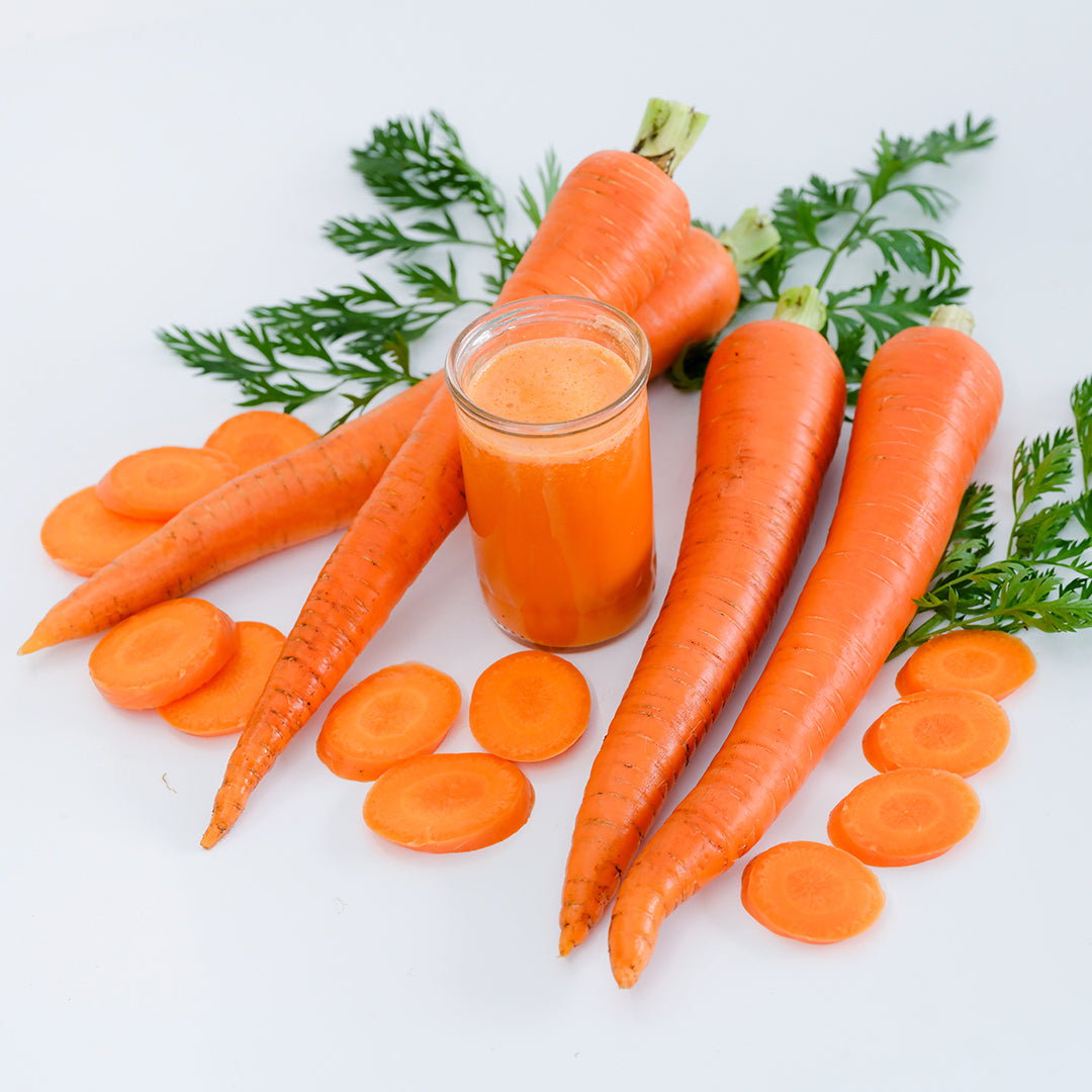 St. Valery Carrots with juice and slices on a white background.