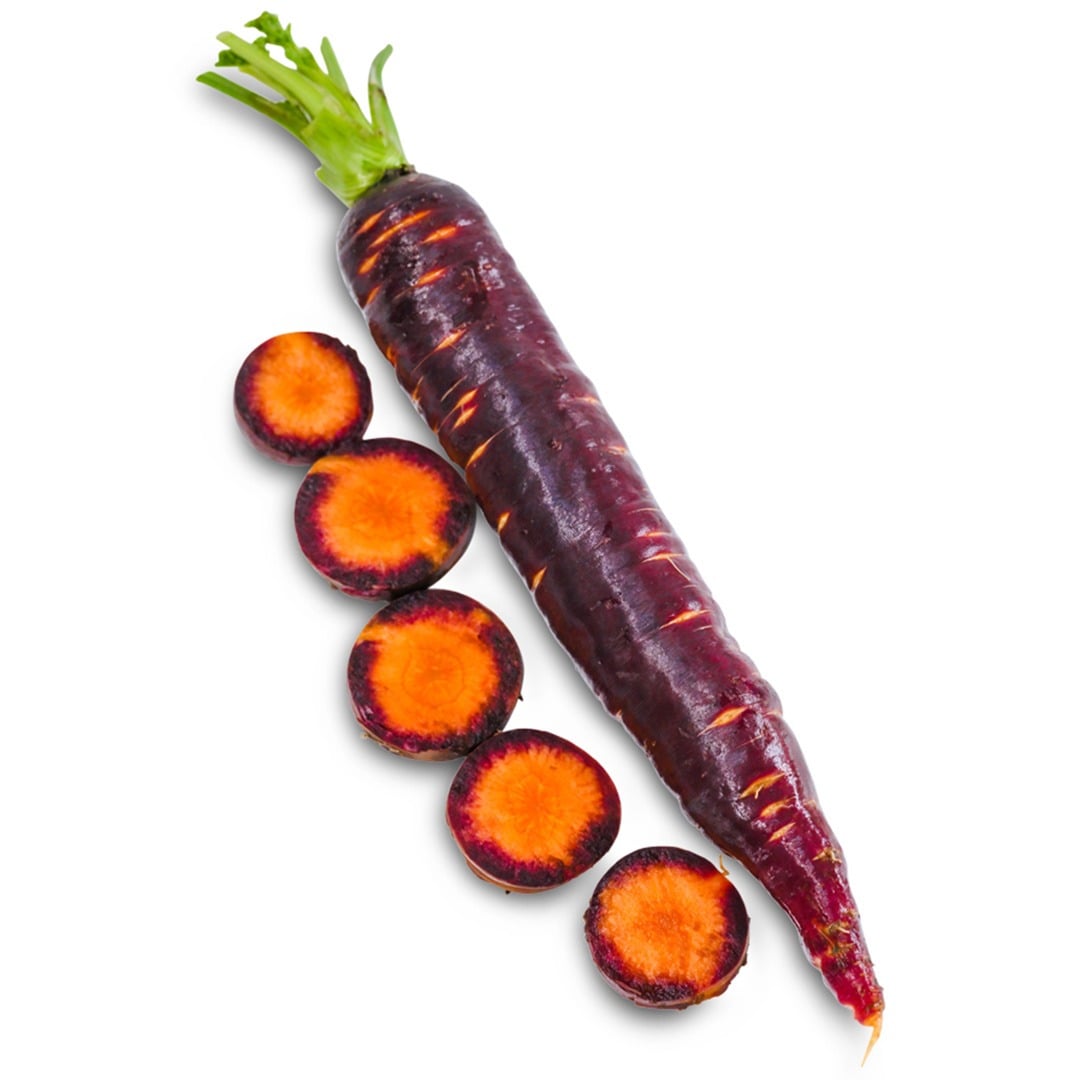 A whole Lila Lu Sang carrot next to slices on a white background