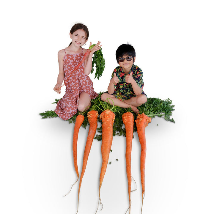 Two smiling children with Manpukuji Carrots on a white background.