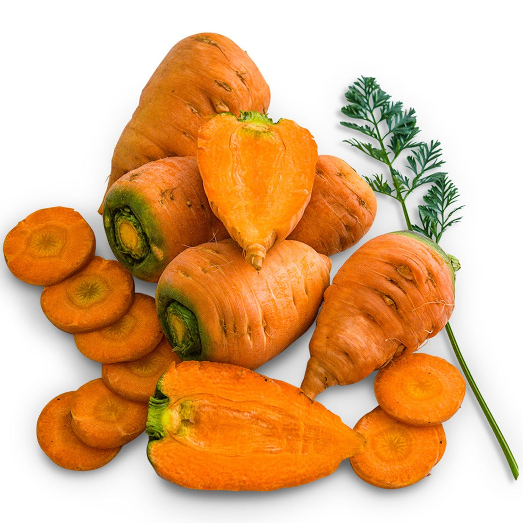 Sliced and whole Oxheart Carrots on a white background.
