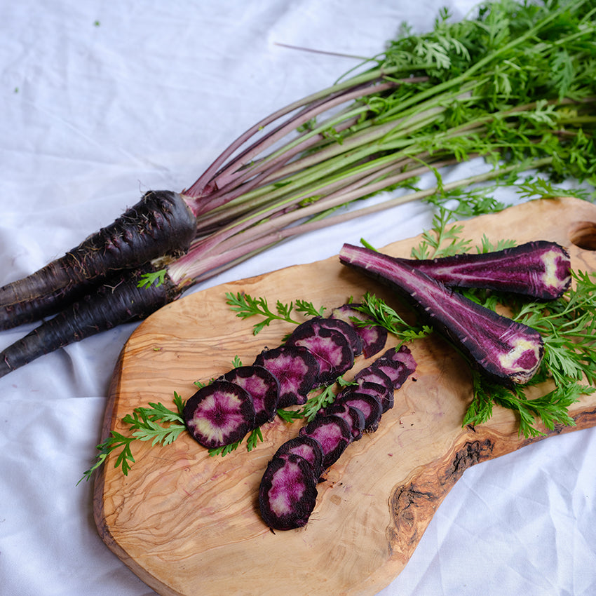 Pusa Asita Carrot slices on wooden plank.