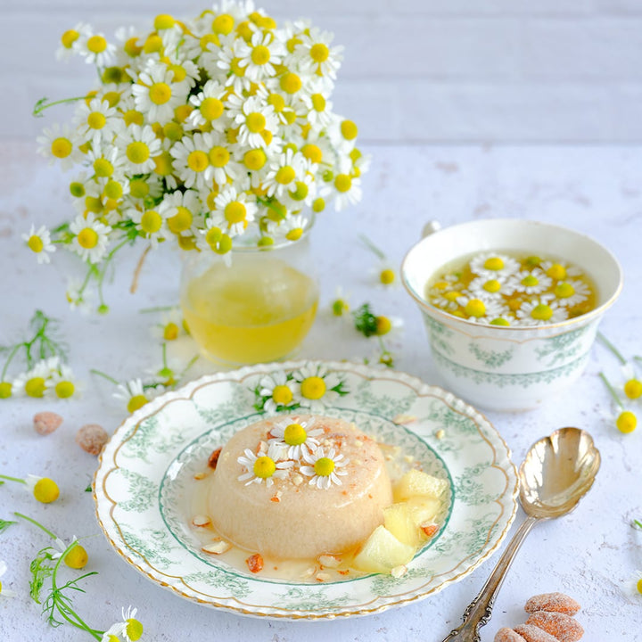 Zloty Lan Chamomile tea with a Panna Cotta recipe and a bouquet of chamomile on a light background.