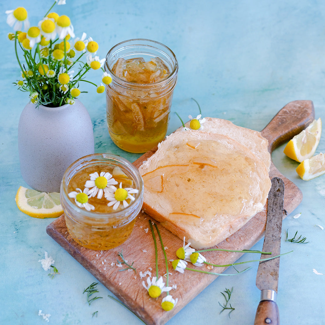 Zloty Lan Chamomile lemon jam on bread with flowers and lemon slices.