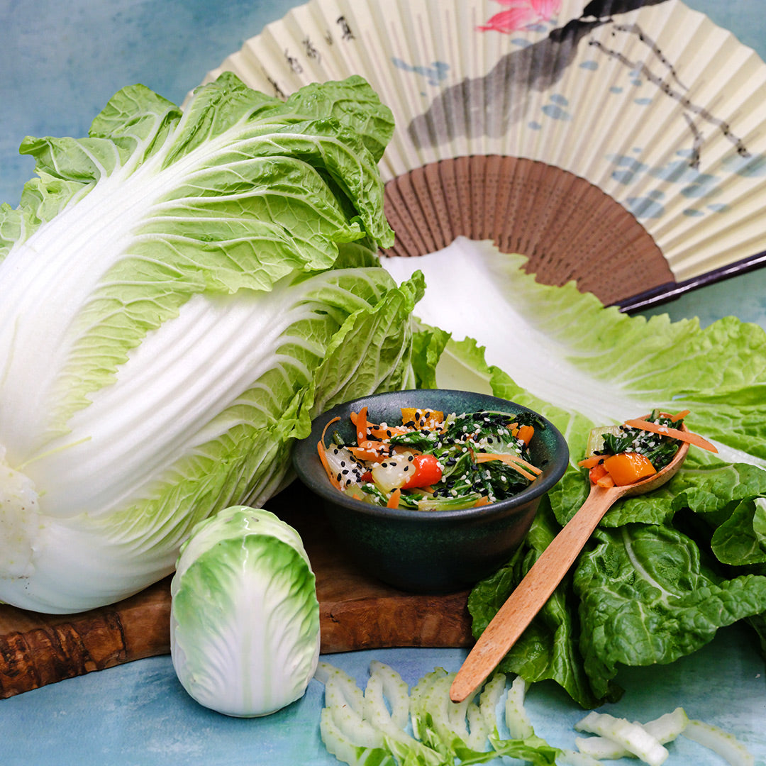 Hilton Chinese Cabbage with a recipe in a bowl and props.