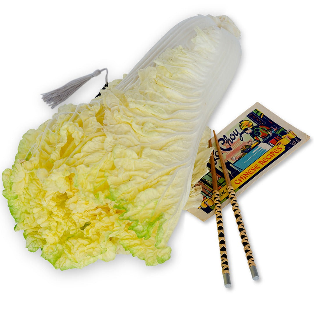 Golden Beauty Chinese Cabbage with chopsticks on a white background.