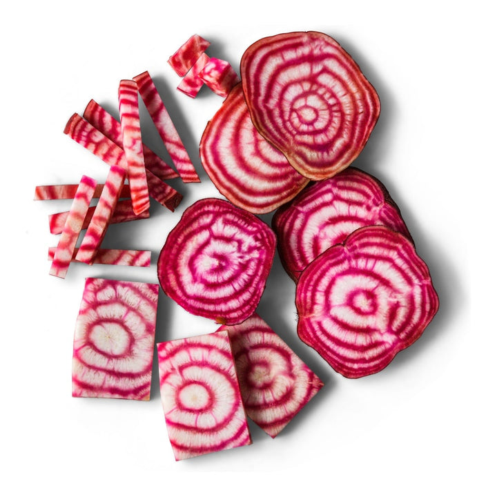 Sliced and cut Chioggia Bassano Beets arranged on a white background.