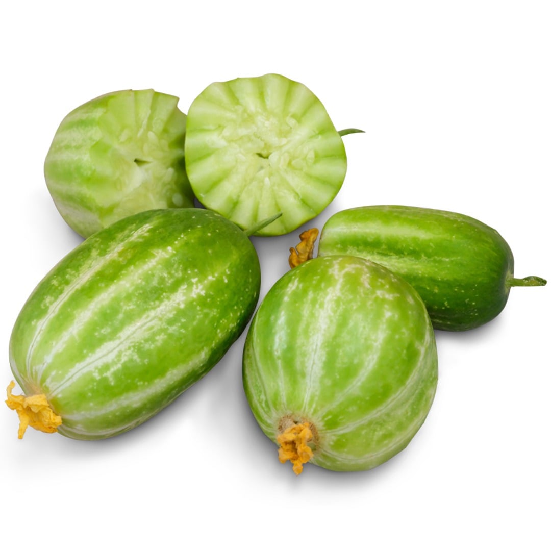 Sliced and whole Richmond Green Apple Cucumbers on a white background.
