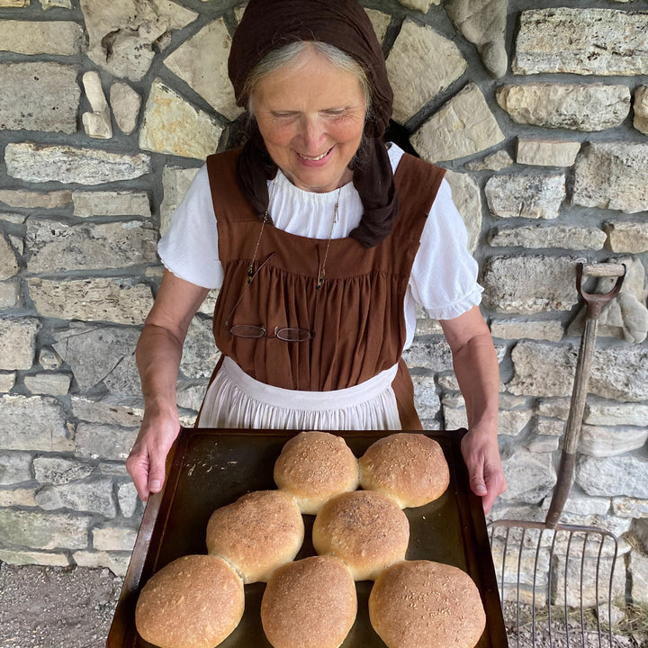 Debbie Gettle holding a fresh batch of bread made from Old World Sourdough Starter.