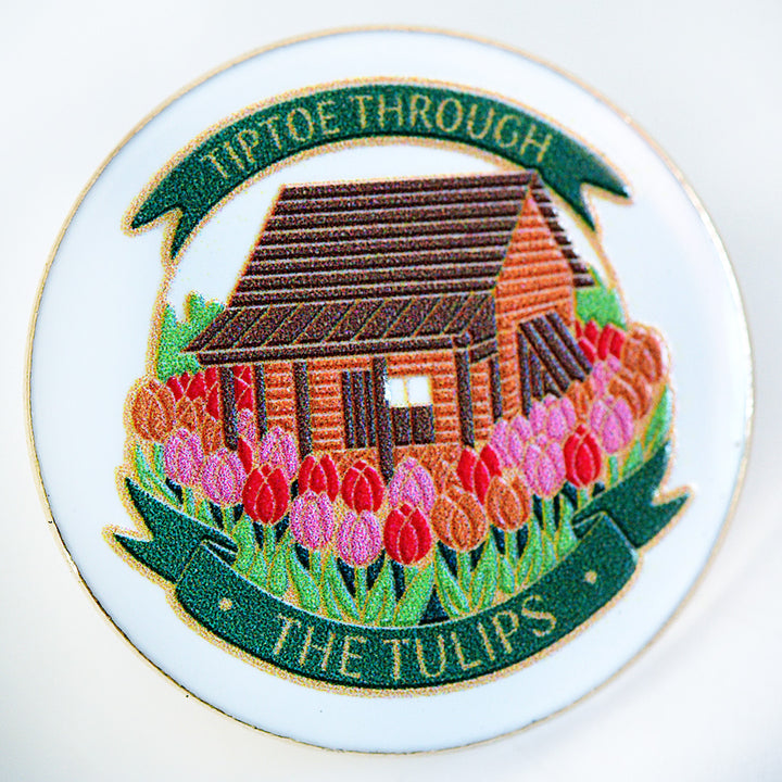 A close-up view of the Baker Creek Limited Edition Tulip Cabin Pin.