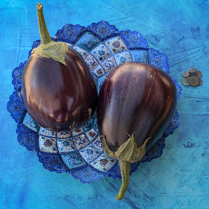 Aswad Eggplant on blue plate and background.