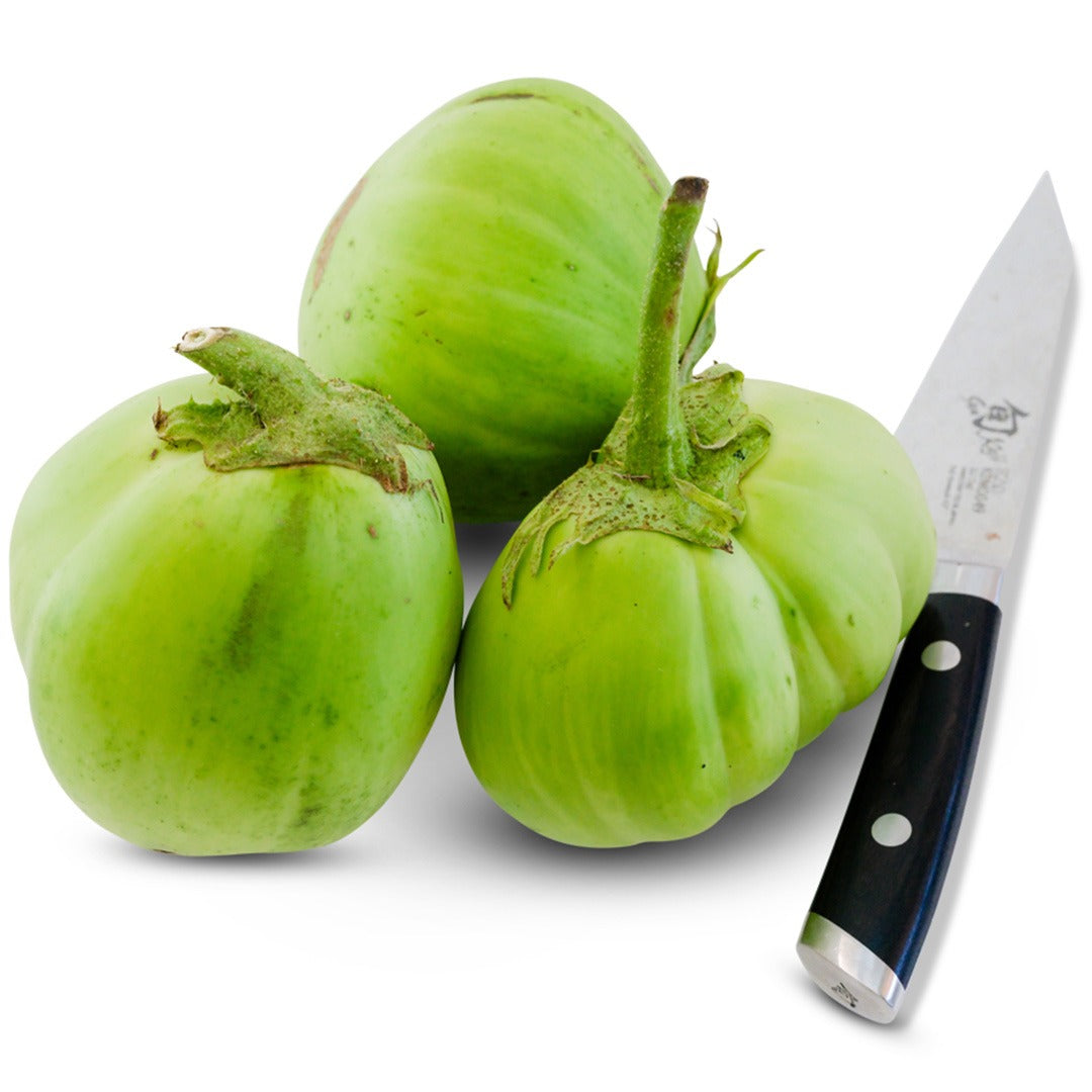 Trio of Saitama Ao Daimaru Eggplant with black handled knife on a white background.
