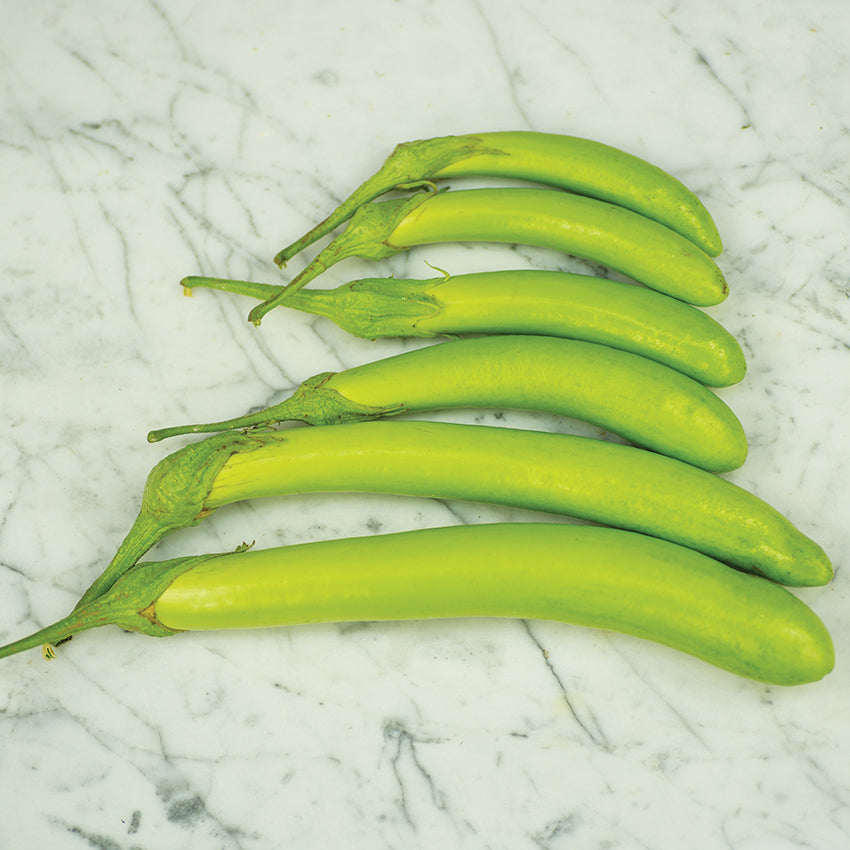 Thai Long Green Eggplant on marble countertop.