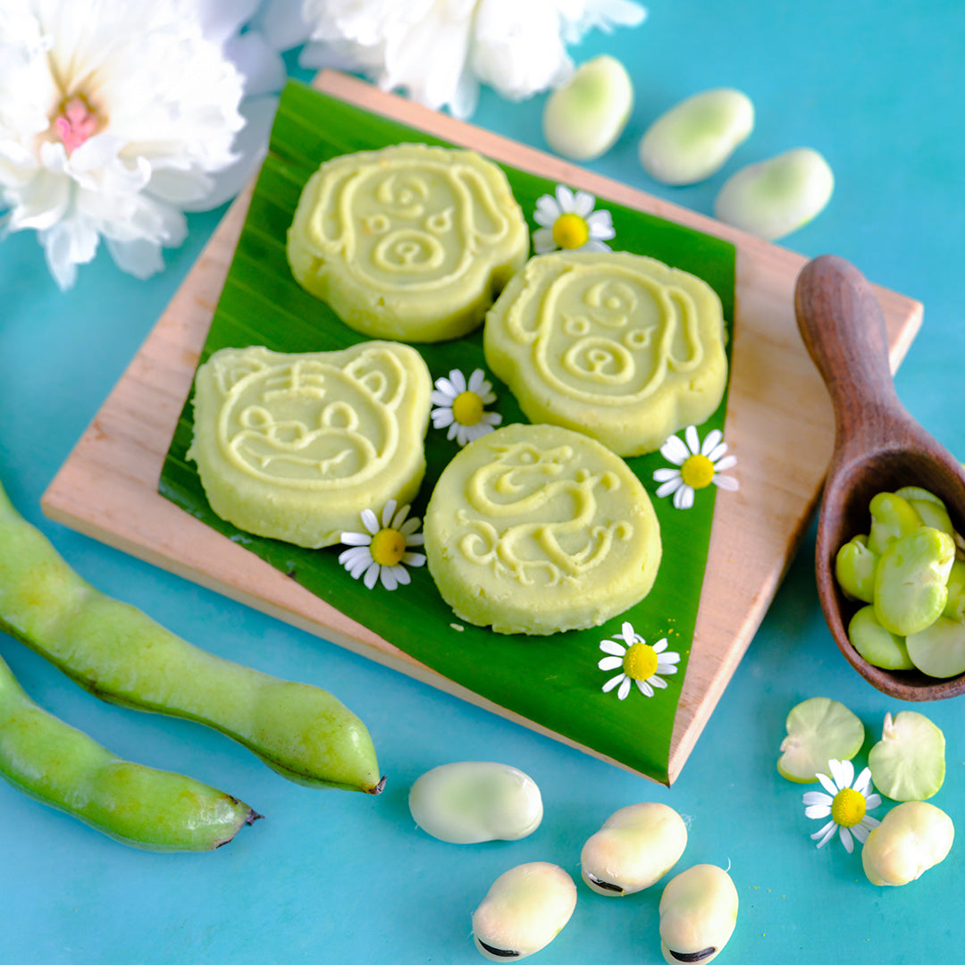 Broad Windsor Fava Beans cookie recipe arranged on a wooden board surrounded by beans.