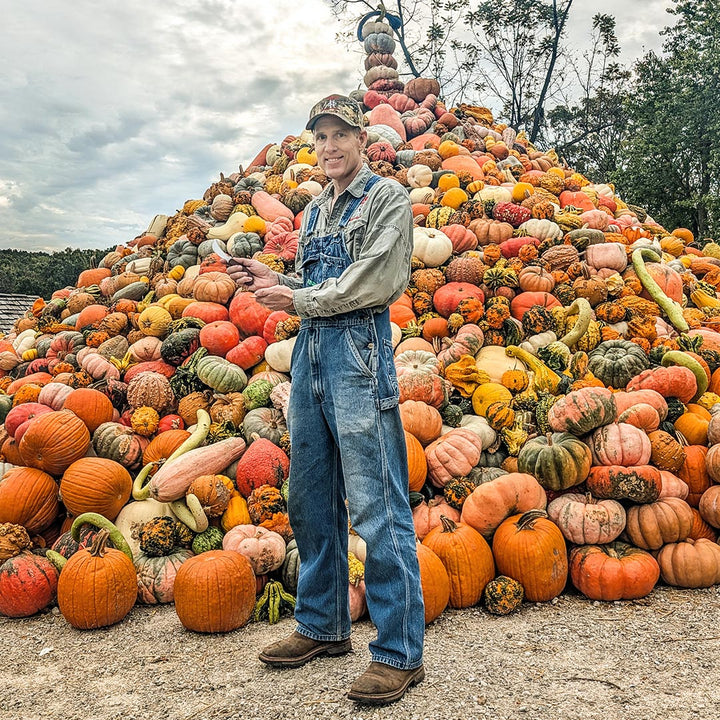 Cody Hughes smiles while holding his handcrafted Ozarks Harvest Knife.