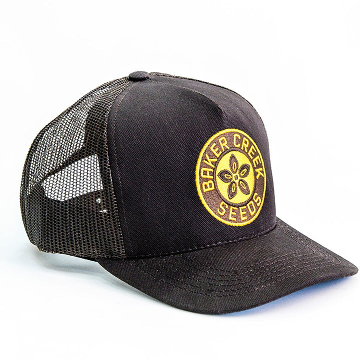 A side view of a single Brown Baker Creek Organic Cap on a white background.
