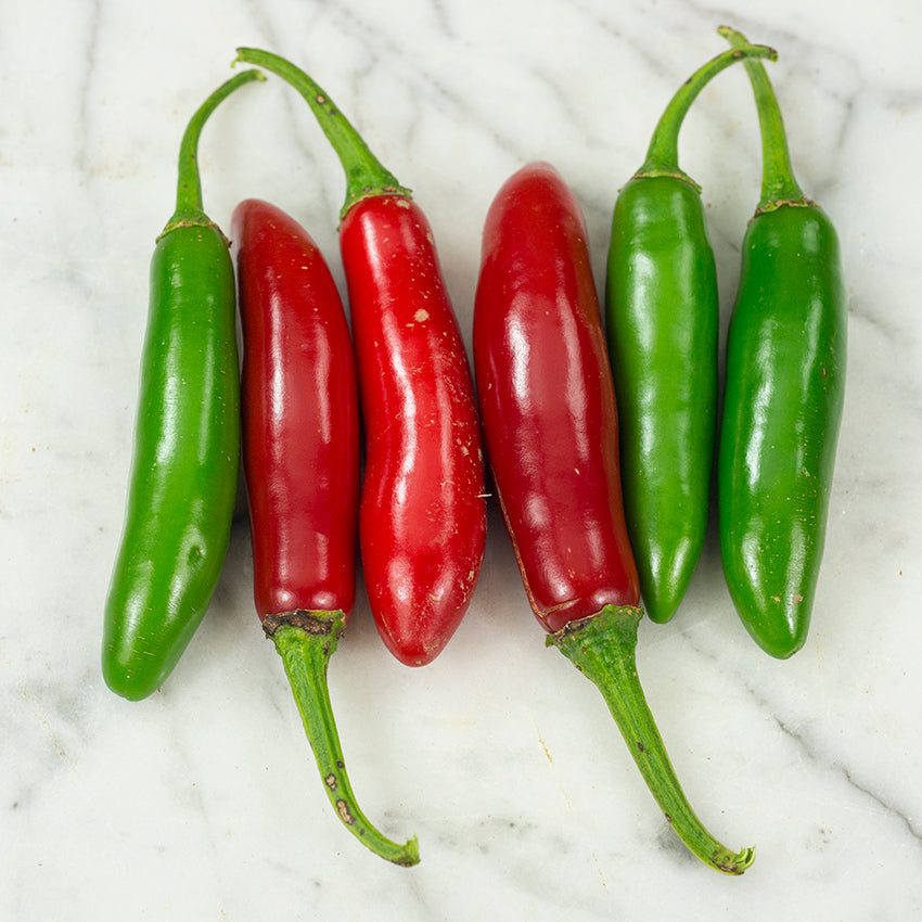 Serrano Tampiqueno Peppers on marble countertop.