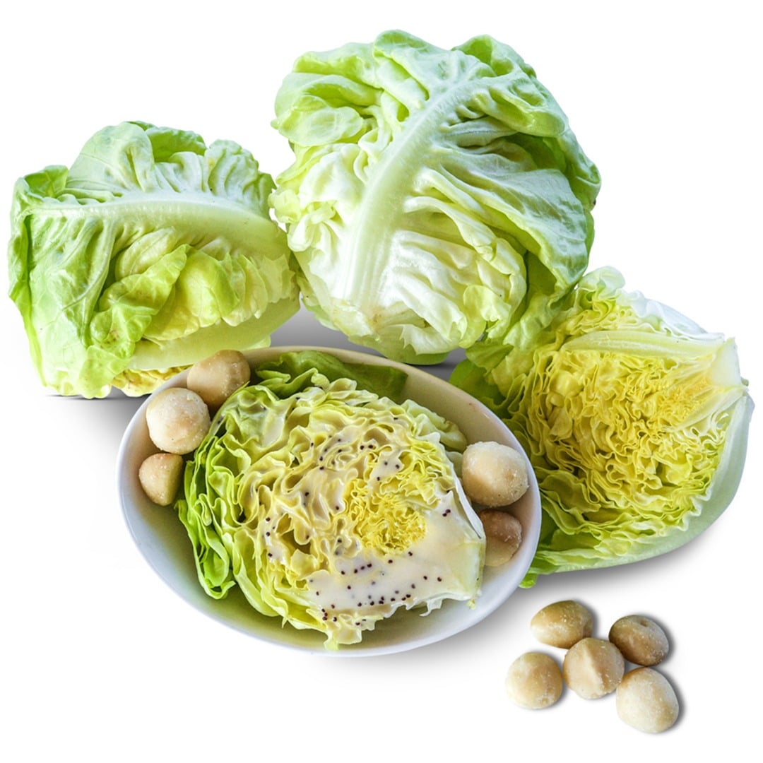 Whole and cut Tennis Ball Lettuce on a white background.