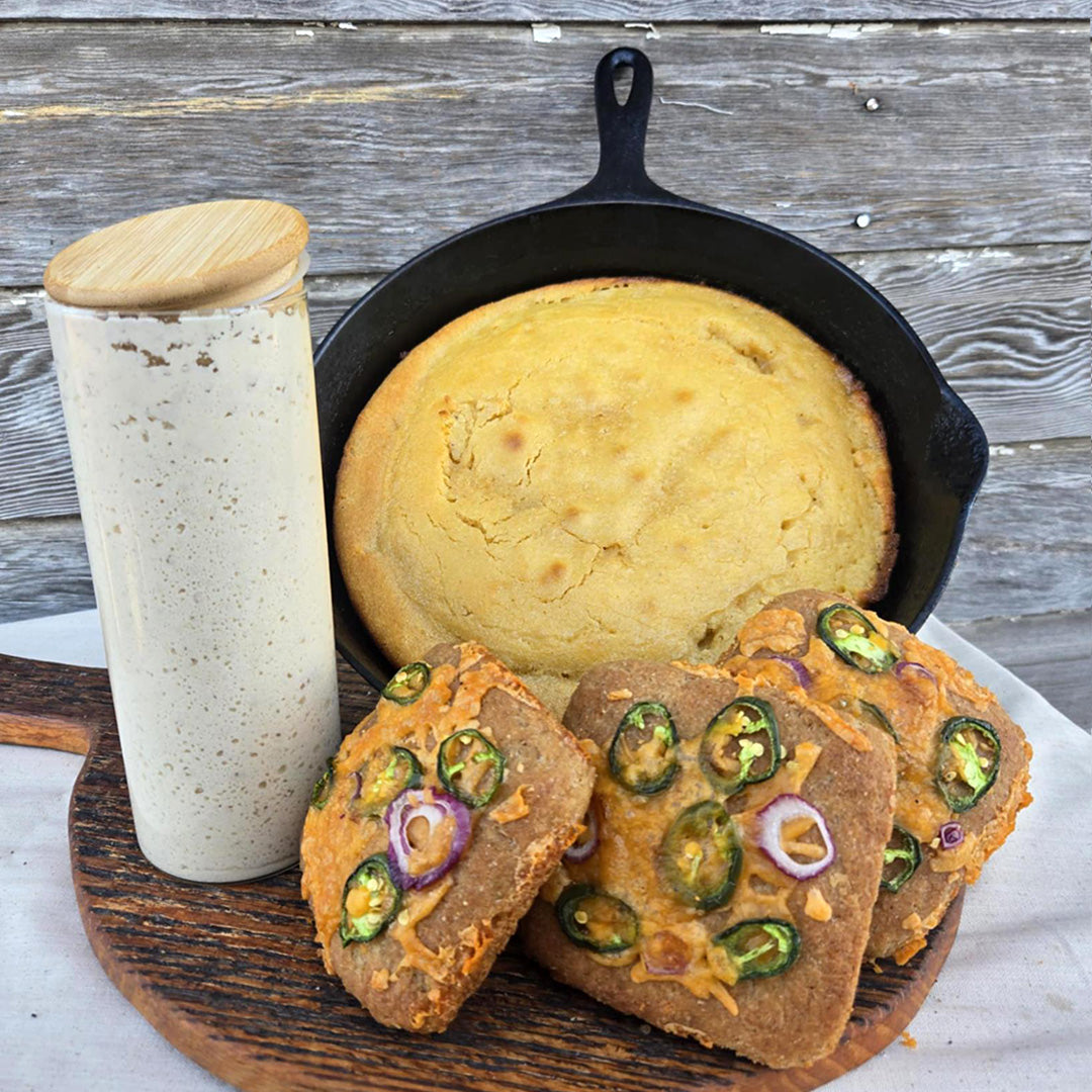 Amazing Sourdough Rice Starter with bread in a cast iron skillet on a wooden background.