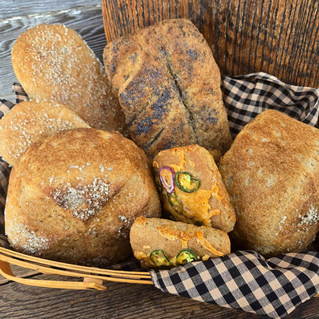 Amazing loaves of bread made from Amazing Sourdough Rice Starter on a wood background.