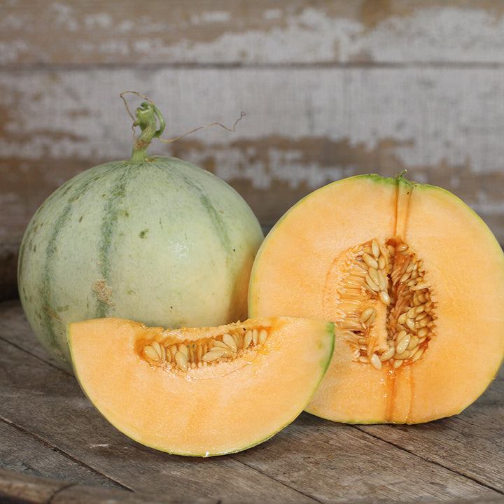 Charentais Melon, whole, halved and quartered.