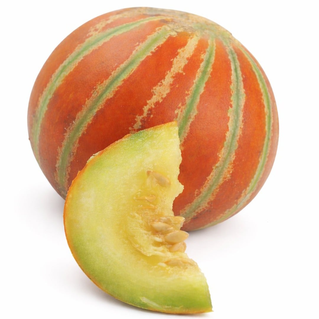 Kajari melon and slice against a white background.