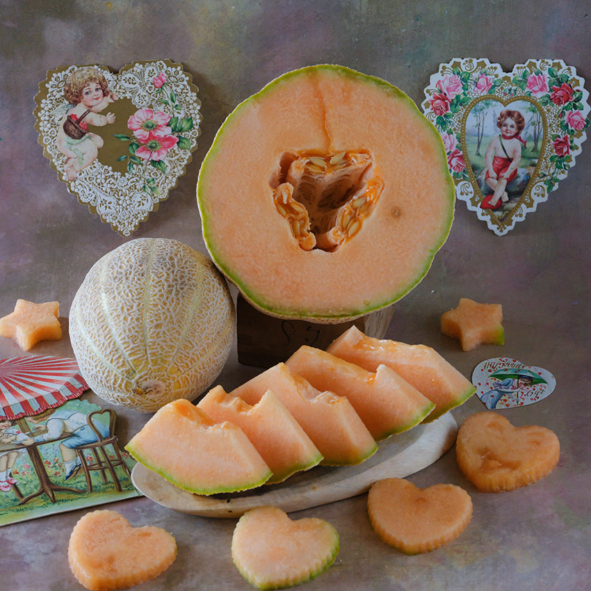 Sweet Passion Melon halved exposing "heart" center.
