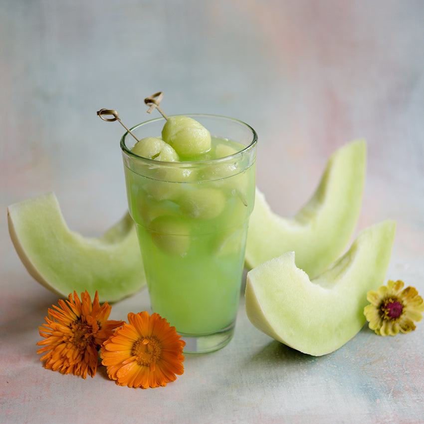 White Lanzhou Melon drink on light pastel background with flowers.