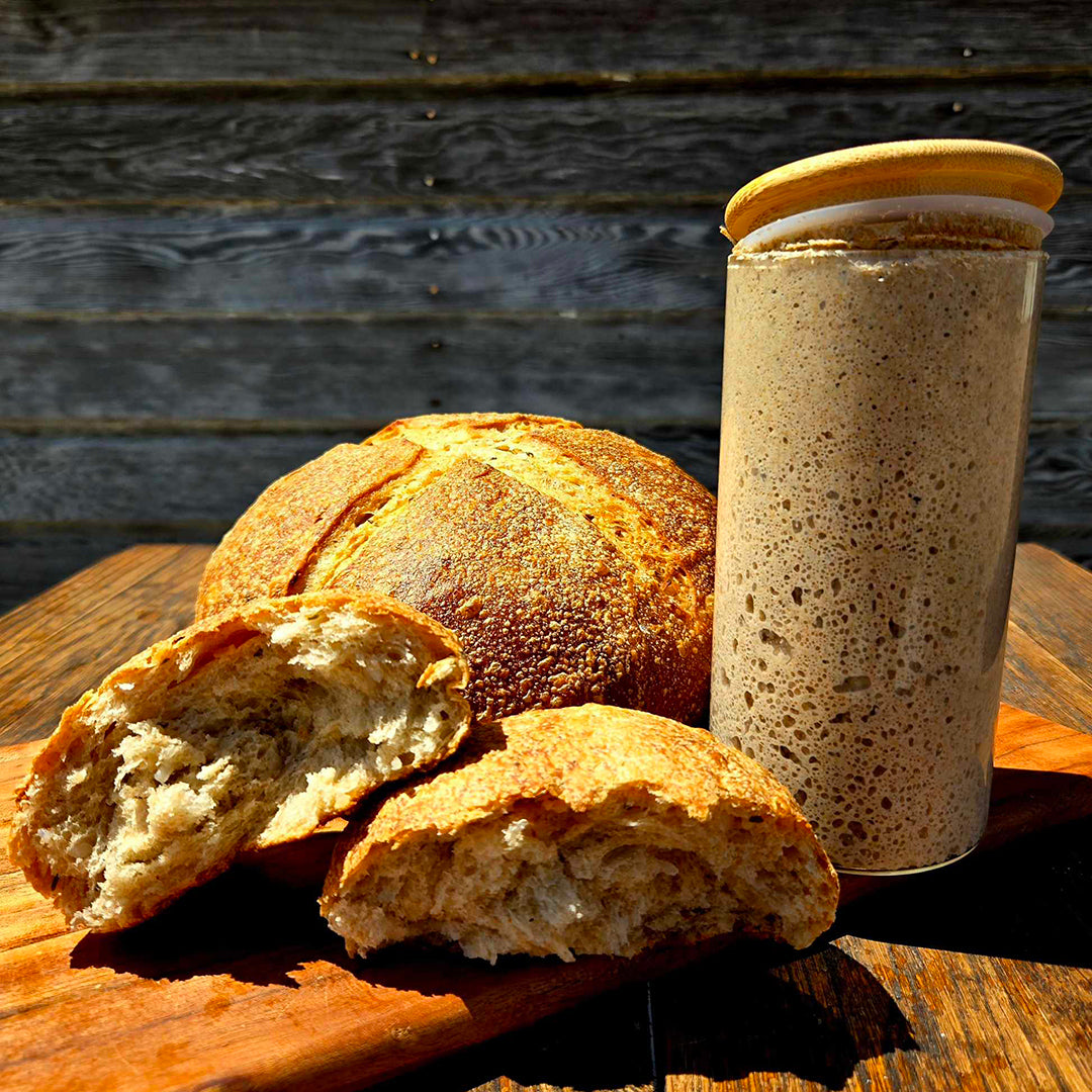 Ms. Debbie’s Rye Starter With loafs of bread on a wood table.