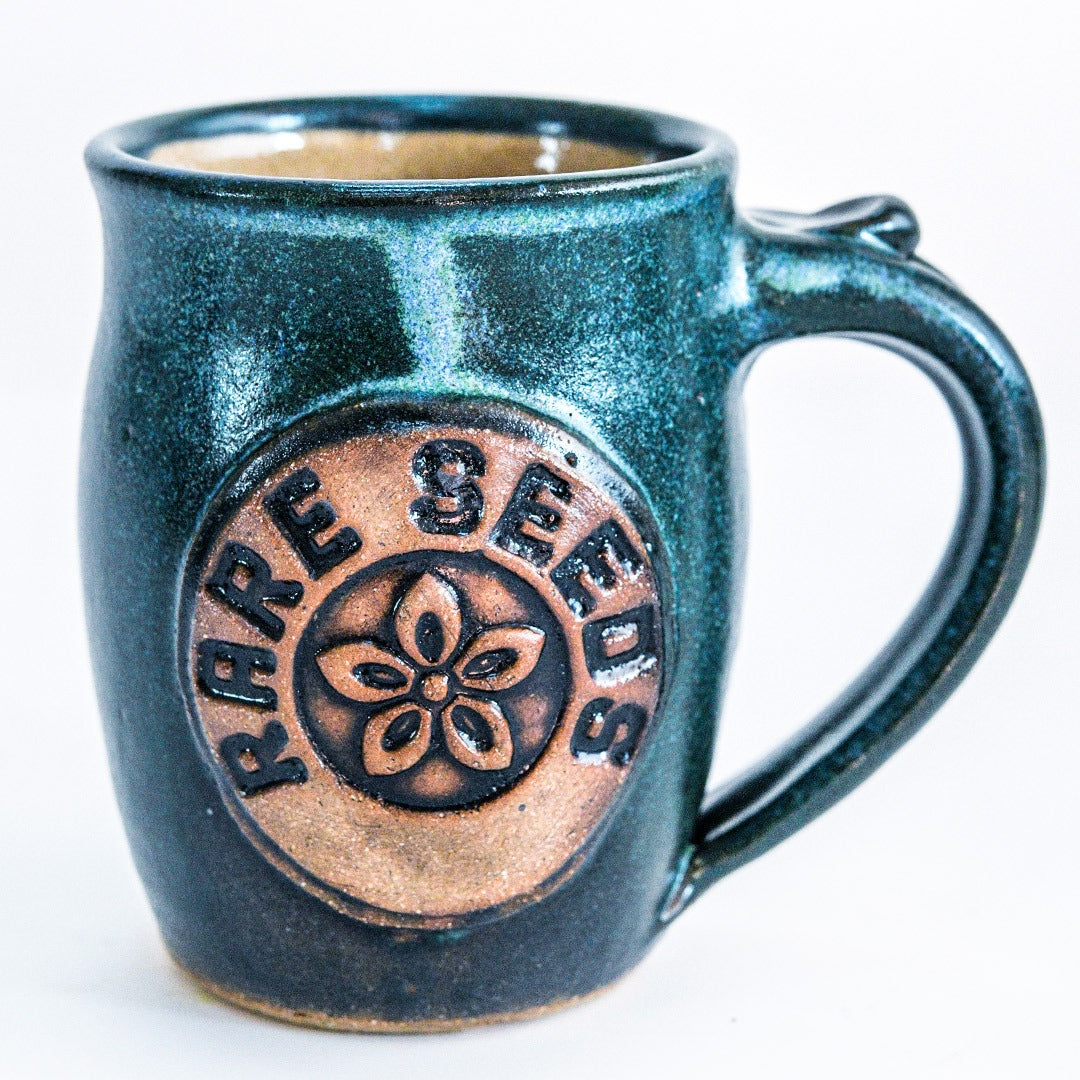 A single Handmade Green/Blue Stoneware Mug with RareSeeds logo on a white background.
