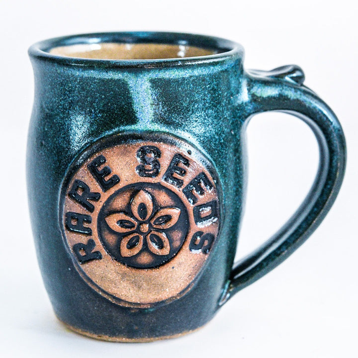 A single Handmade Green/Blue Stoneware Mug with RareSeeds logo on a white background.