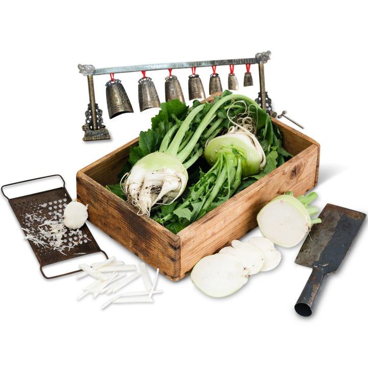 Bald Head Mustard in a wooden box with props on a white background.