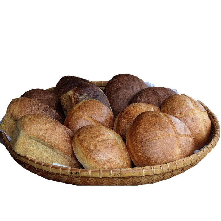 Many loaves of bread made with Old World Sourdough Starter on a white background.
