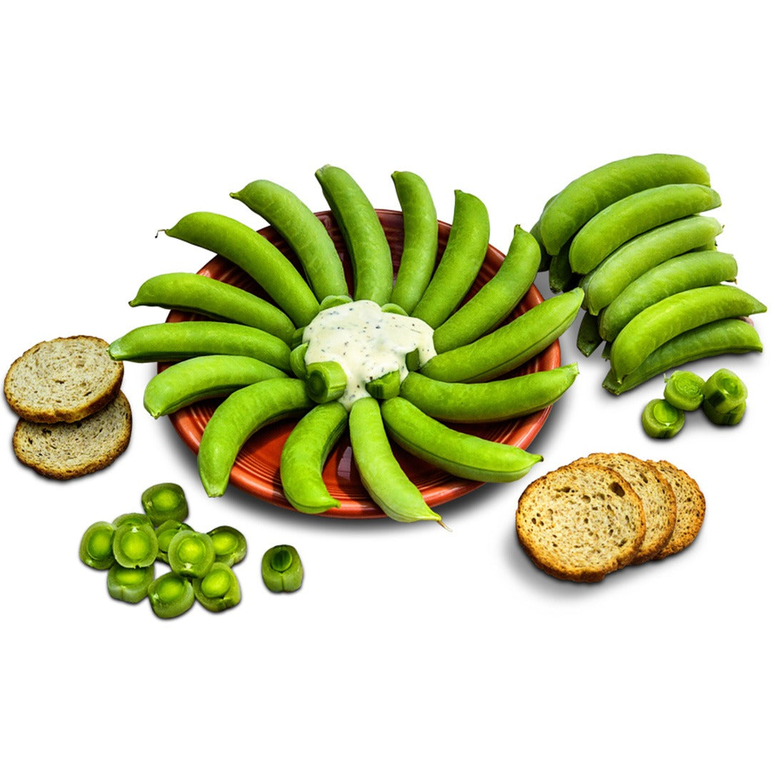 Sugar Bon Snap Pea pods on a red plate with dip on a white background.