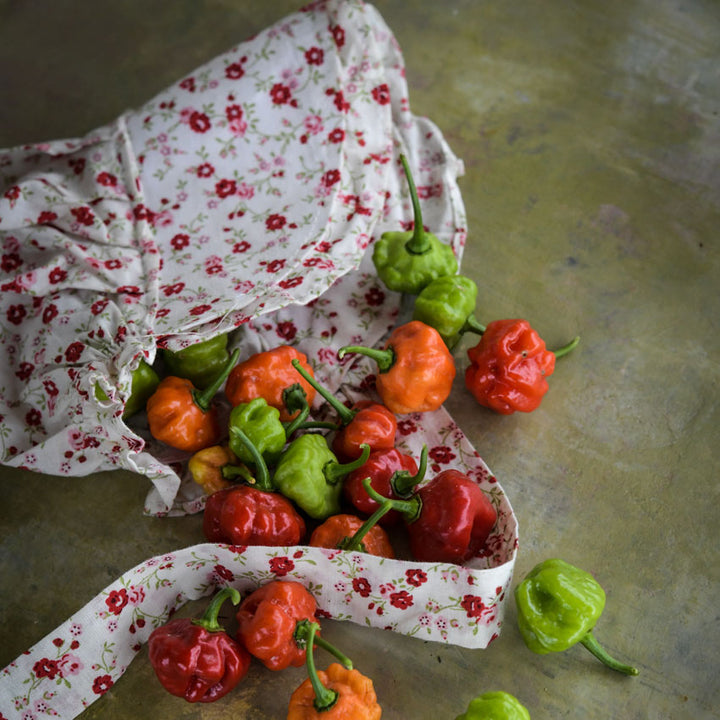Several Bonnet Sweet Peppers in a flower-patterned women&