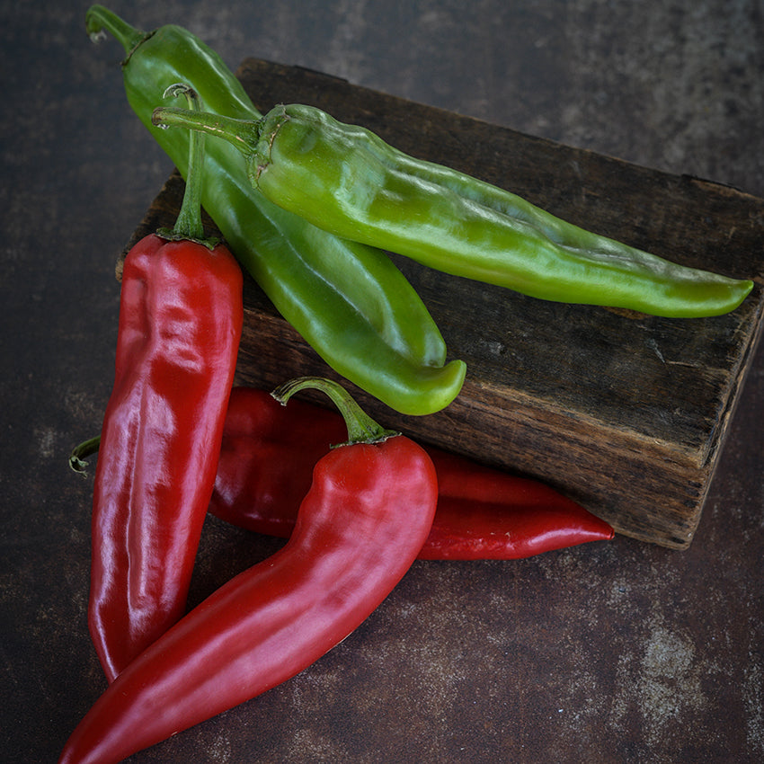Big Jim Peppers, green and red, on wooden box.