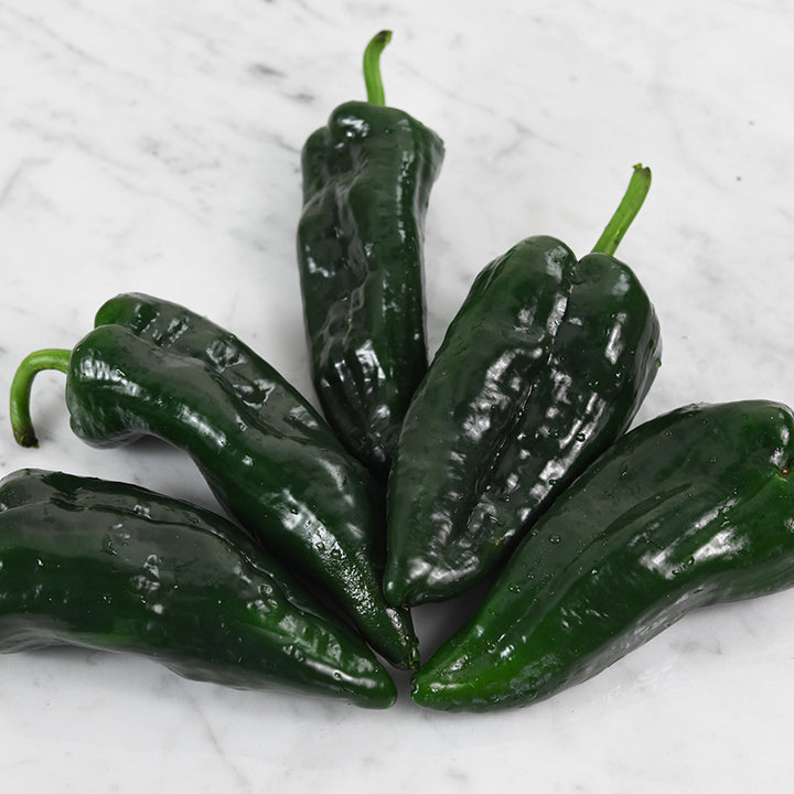 Poblano Pepper spray on marble background.