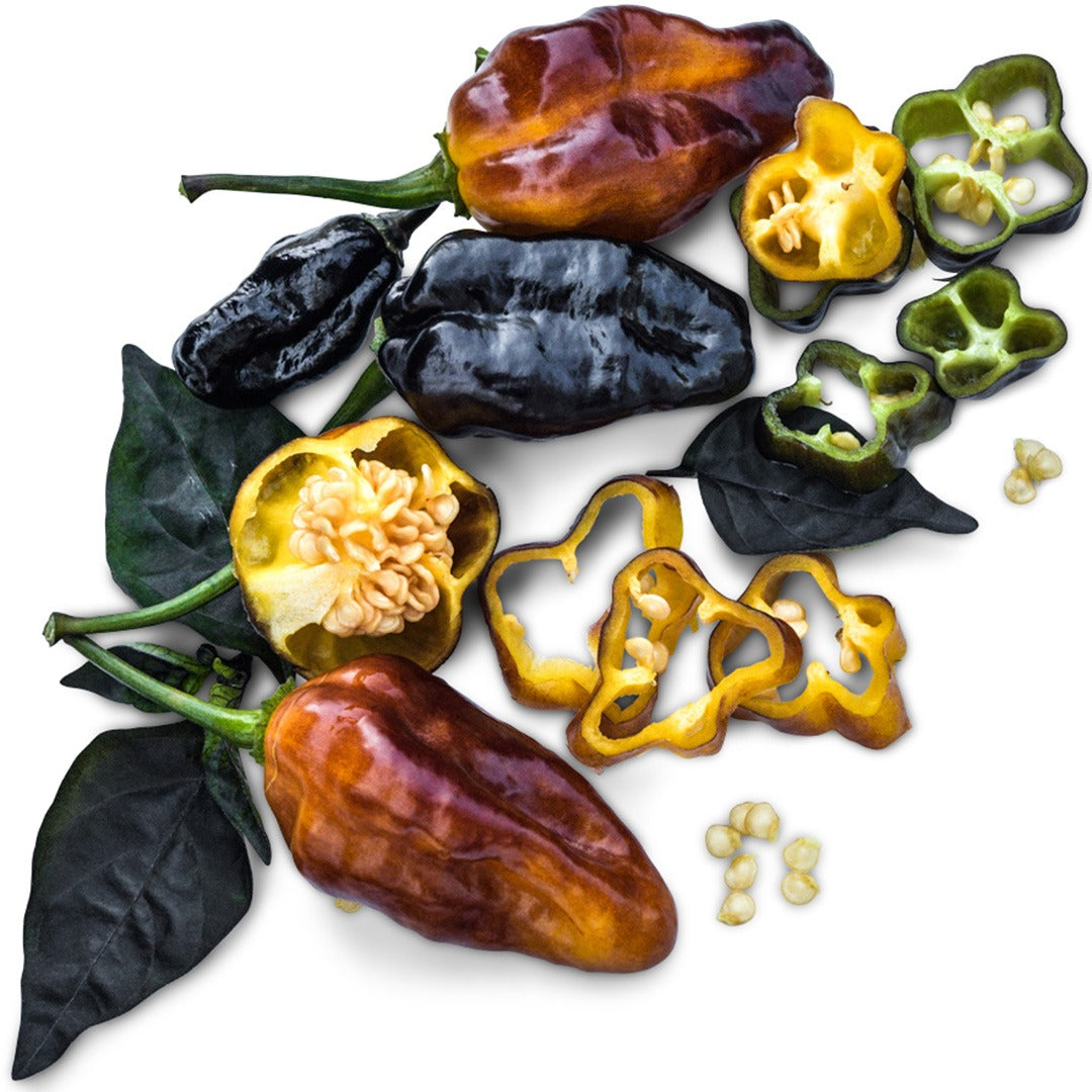 Whole and sliced Puma Hot Peppers on a white background.