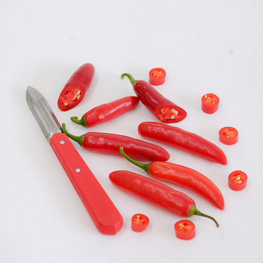 Serrano Tampiqueno Peppers sliced on white background.