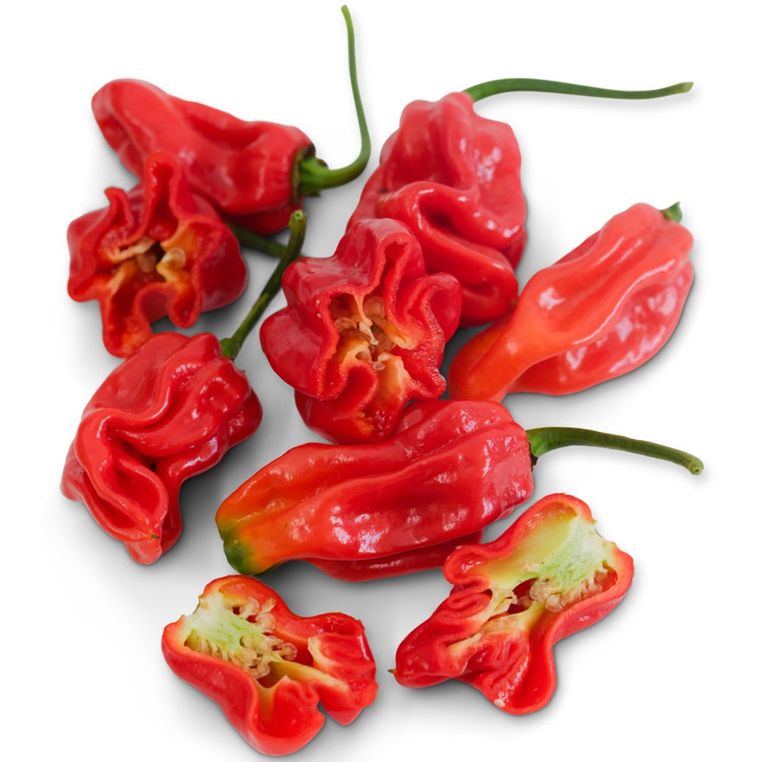 Whole and cut Arroz Con Pollo Sweet Peppers on a white background.